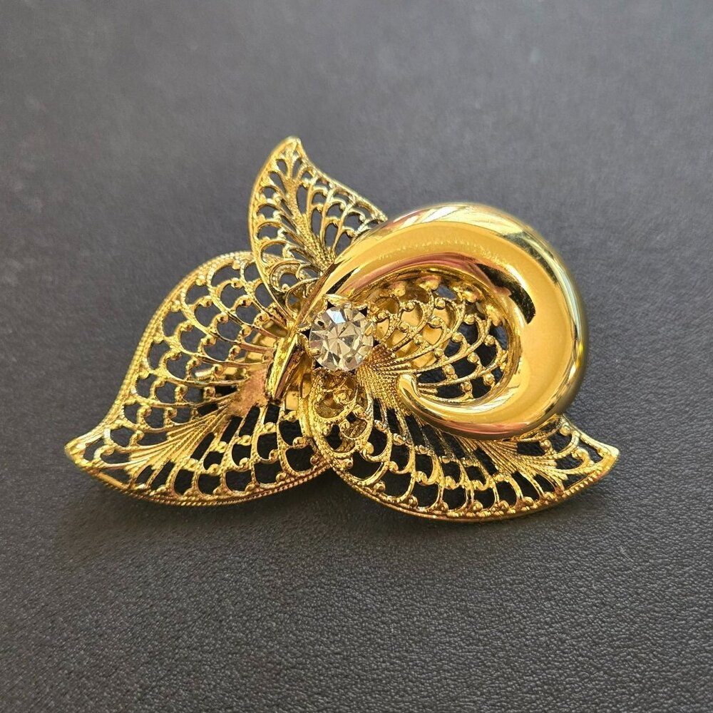 Vintage Gold Tone Filigree Brooch with Clear Rhinestone Swirl Leaf Design